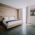 The Preston House and Hotel in Riverhead guest room with wood platform bed and floor-to-ceiling window