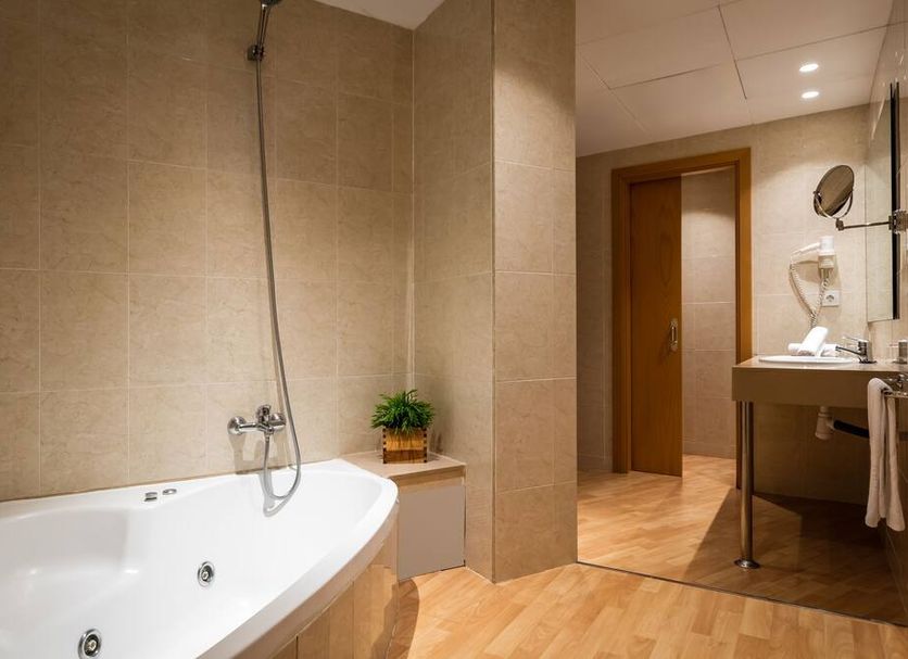 Alegria Plaza Paris in Lloret de Mar bathroom with soaking tub, shower, and vanity