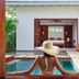 Ka'ana Resort, San Ignacio: guest in plunge pool facing open villa with bedroom and patio seating