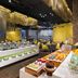 Aloft Bengaluru Outer Ring Road buffet dining area with yellow seating and dessert display in Bengaluru