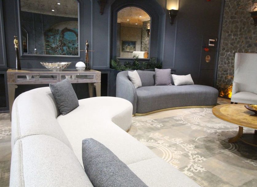 Funda Hotel Trabzon lounge with curved sofas, round coffee table, fireplace, and ornate decor