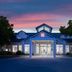 Hilton Garden Inn Roseville exterior at dusk with illuminated entrance and pink sky