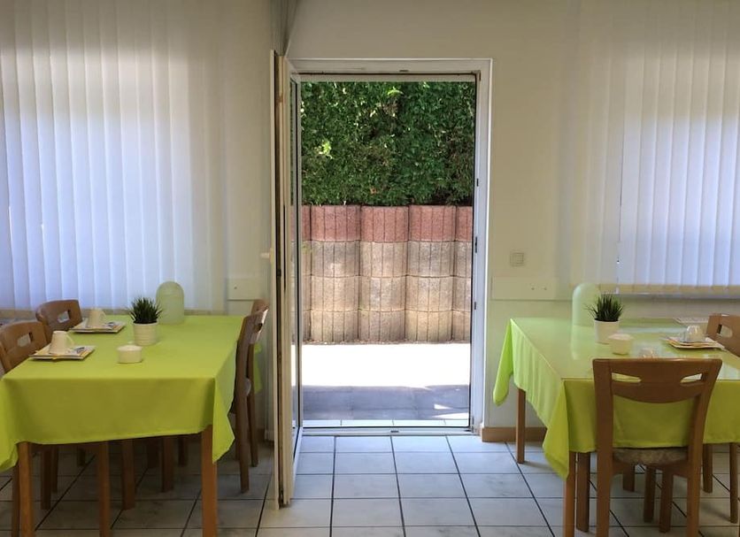 Hotel Ölberg in Königswinter dining area with tables by an open door to a patio