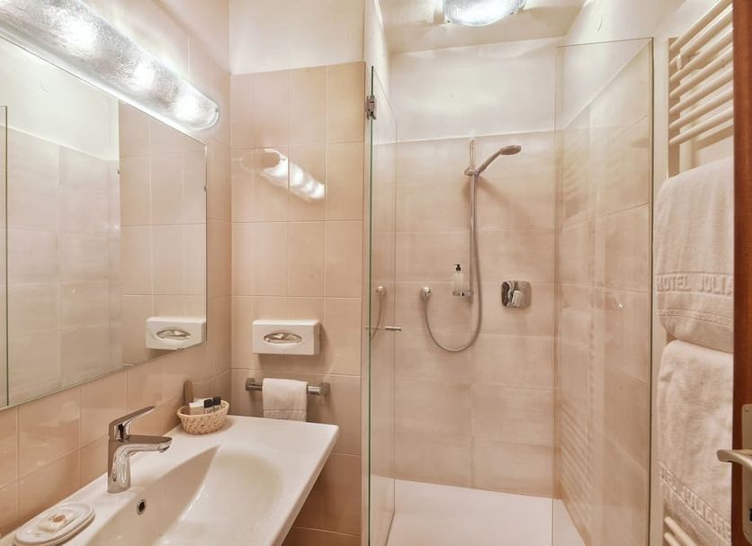 Hotel Juliane in Merano bathroom with glass shower, wall mirror and sink