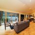 The Whispering Pine Lodge in Spean Bridge living area with lake view, sofa, dining table and kitchenette