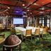Lake Placid Lodge meeting room with conference table, projector screen, rustic decor and forest-style accents
