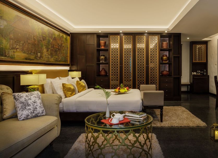 Thai Akara - Lanna Boutique Hotel Chiang Mai room with king bed, sofa, desk and decorative lanterns