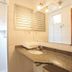 Pampulha Flat Belo Horizonte bathroom vanity with granite countertop, mirror, and walk-in shower