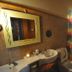 Bathroom at Baia Baia Resort in Ko Phi Phi with sink, toilet, shower curtain and pebble floor accents