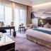 Xiang Ming Luxury Airport Hotel, Huangshan guest room with mountain mural and twin bedside lamps