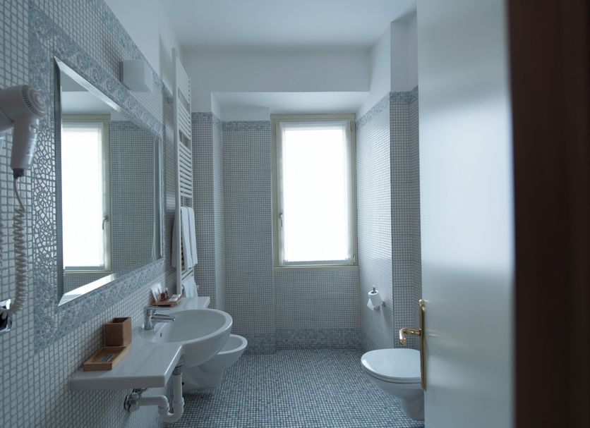 Hotel Villa Colico bathroom in Colico with double sinks, bidet, and mosaic tile walls