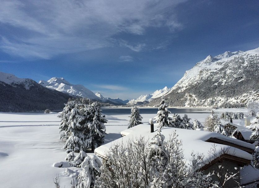 Hotel Bellavista in Silvaplana with snowy lake and mountain views from a winter chalet