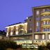 Rizzi Aquacharme Hotel & Spa in Darfo Boario Terme exterior at dusk with lit balconies