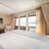 Seerose Resort & Spa in Meisterschwanden guest room with balcony and lake view