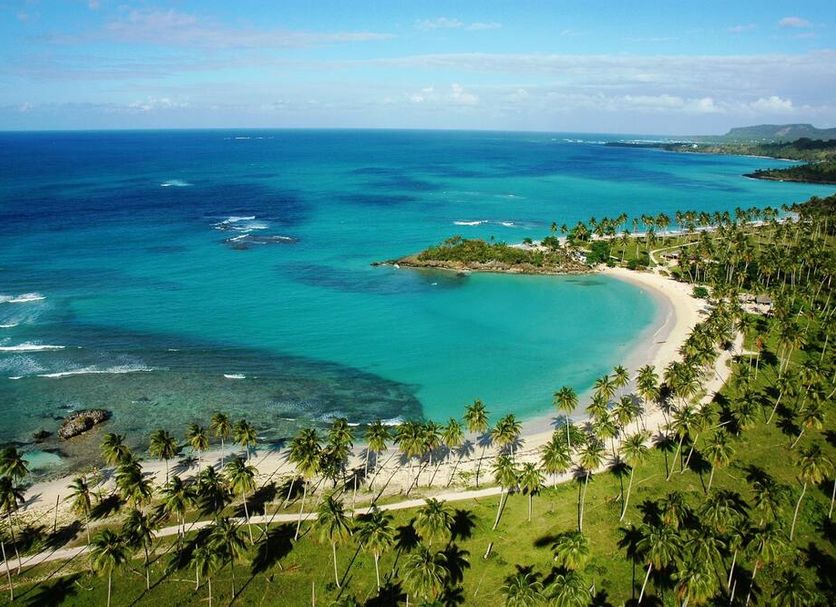 The Bannister Hotel in Samaná with a tropical beach, palm trees, and turquoise ocean views