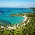 The Bannister Hotel in Samaná with a tropical beach, palm trees, and turquoise ocean views