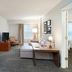 Residence Inn by Marriott New Bedford Dartmouth suite with living area, sofa, dining table and bedroom doorway
