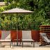 Sweet Hotel in Schiavon outdoor terrace with loungers, umbrella and lush greenery