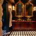 Palma Riad in Palma de Mallorca: elegant bathroom with twin mirrors, double sinks and black-and-white tiled floor