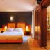 Hotel Villa Delle Rose - Malpensa bedroom in Oleggio with double bed, bedside lamps and wood wardrobe