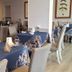 Hotel & Restaurant San Marco Ab dining room in Toscolano Maderno with set tables and upholstered chairs