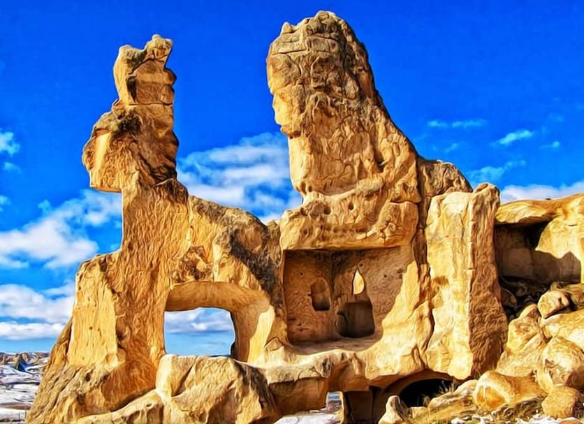 Bedrock Cave Hotel in Göreme with sculpted rock formations against a blue sky