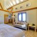 The Grove Cromer guest room with bed, sofa, wall-mounted TV and window seating area in Cromer