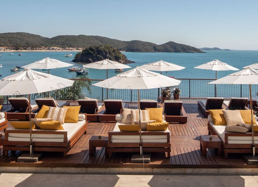 Casas Brancas Boutique Hotel & Spa in Búzios with oceanfront terrace, lounge chairs and umbrellas