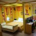 Time Motel in Gyeongju room with bed, desk, TV, and bright colorful wall decor