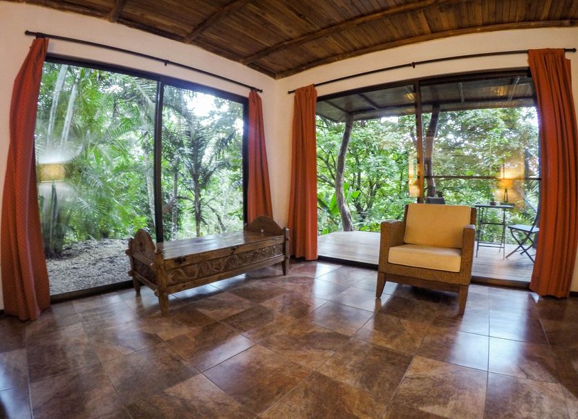 Lodge Margouillat in Tambor, open-air room with forest views and a balcony seating area
