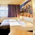 B&B Hotel Frankfurt City-Ost room with bunk bed, twin bed and cityscape wall art in Frankfurt am Main