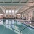 Indoor pool at Residence Inn by Marriott Providence Lincoln in Lincoln with lounge chairs and large windows