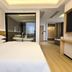 International Haiyuan Resort Hotel in Nantong guest room with bed, wood flooring, and modern interior