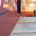 Hilltown Hotel in Madikeri staircase with marble steps, white balustrade and warm lobby lighting