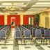 Le Plaza Hotel in Port Au Prince conference room with rows of blue chairs and chandeliers