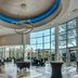 Sheraton Eatontown Hotel in Eatontown lobby with high ceilings, circular chandelier, and floor-to-ceiling windows