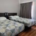 Baymont by Wyndham San Antonio Airport room with two beds, patterned bedding and a window with curtains