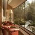 Crossbasket Castle, Glasgow: riverside lounge with leather chairs beside floor-to-ceiling windows