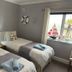 Hogwarts Bed and Continental Breakfast in Sheerness, twin guest room with window view and bedside lamp