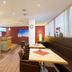 Hotel Alpenland in Sankt Anton am Arlberg lounge with tables, booth seating and front desk