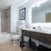 Independence Stay Hotel and Long term suites bathroom in Houghton with tub-shower combo and vanity