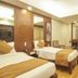Rkn Hotel Pondicherry twin-bed guest room with wood flooring, desk, and mirror vanity