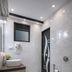 Hotel Harmony in Khajurāho bathroom with vessel sink, wall-mounted toilet, and frosted glass window