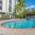 Hampton Inn Sarasota-I-75 Bee Ridge pool area with palm trees and loungers in Sarasota