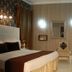 Royal Palace Luxury - Piazza di Spagna hotel room in Rome with bed, chair, mirror, and desk