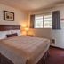 Silver Sands Motel in Rockaway Beach guest room with bed, window view and lamp