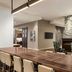 Residence Inn By Marriott New York Jfk Airport lobby lounge in Queens with long communal table and fireplace