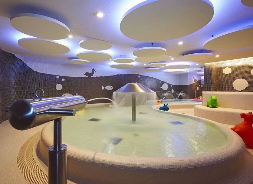 Harmony Hotel in Špindlerův Mlýn features an indoor pool with playful sea-themed decor and ceiling lights.