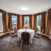 Falcon Crest Lodge in Canmore meeting room with round table and mountain views through large windows