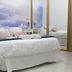 CH La Bañezana, Madrid: bright hotel room with double bed, mirrored wardrobe and cloud mural